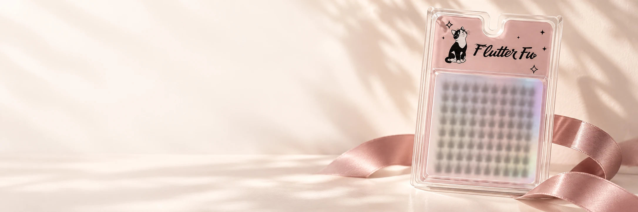Flutter Fu mystery lash gift with a frosted lash window and decorative pink ribbon; style selected at random